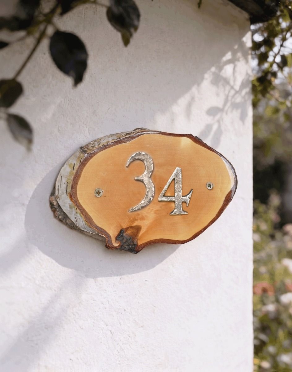 A Number 34 Natural Hard Wood Rustic House Number Sign Mounted on a Sunny White Cottage Wall - Digital Illustration 