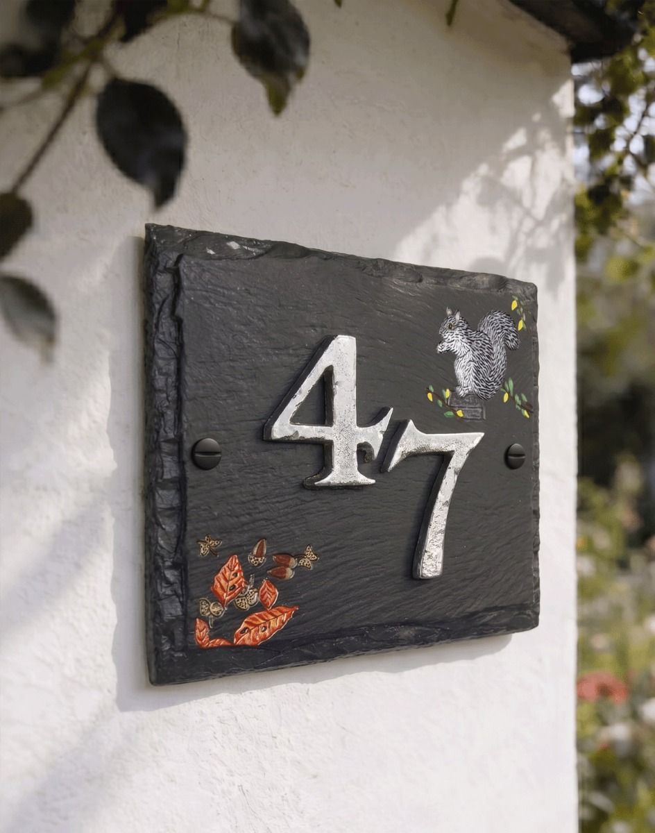 A Number 47 "Hillenbrook Woodland" Squirrel Slate House Number Sign Mounted on a White Sunny Cottage Wall - Digital Illustration