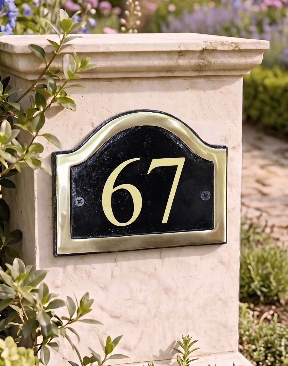 A Number 67 in Vinyl on a Black & Brass Arched House Number Sign Mounted on a Driveway Entrance Wall - Digital Illustration - Digital Illustration 