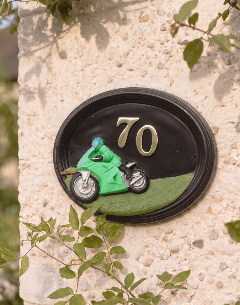 A Number 70 Hand Painted Sport Touring Motorbike House Sign Mounted on a Cream Coloured Sunny Cottage Wall - Digital Illustration