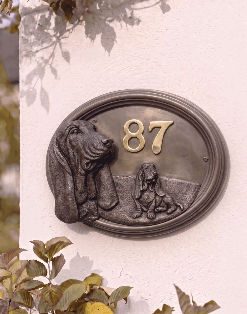A Number 87 Basset Hound House Number Sign in a Bronze Finish Mounted on a Cream Coloured Cottage Wall - Digital Illustration