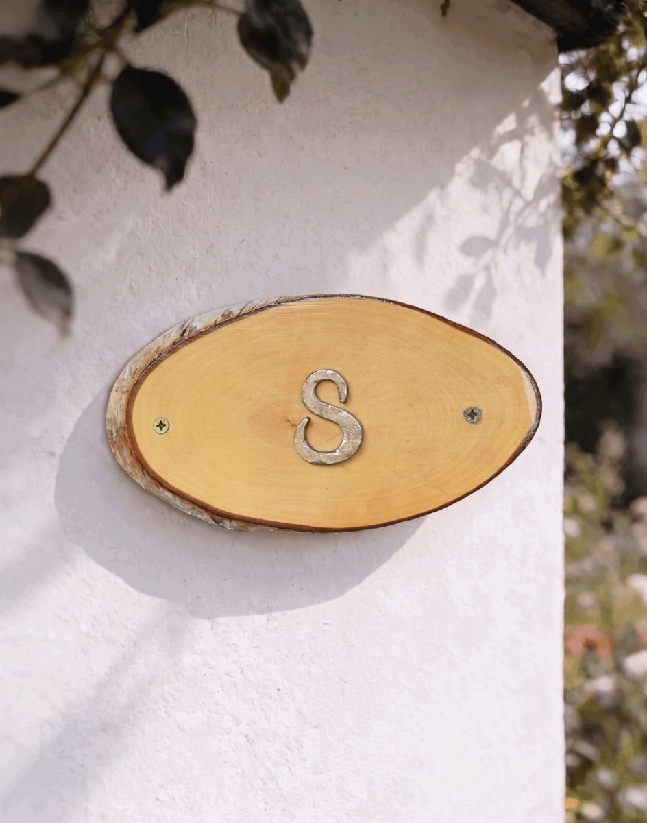 A Number 8 Natural Hard Wood Rustic House Number Sign Mounted on a Sunny White Cottage Wall - Digital Illustration