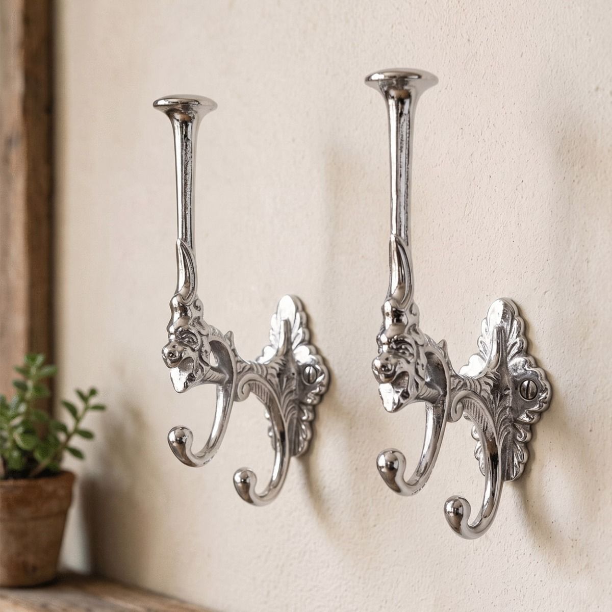 A Pair of Bright Chrome Art Deco Styled 3 Prong Hat and Coat Hooks in a Sunny Home Hallway - Digital Illustration 