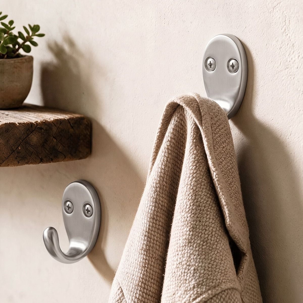 A Pair of Satin Chrome Single Pronged Coat Hook on a Hallway Wall next to a Timber Shelf - Digital Illustration 