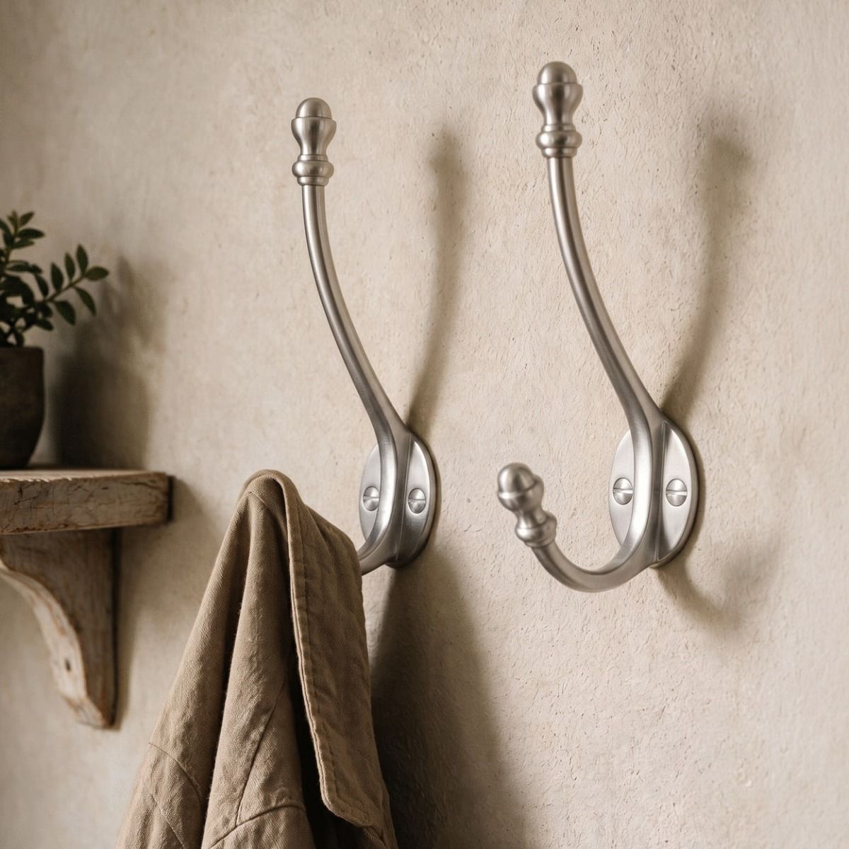A Pair of Satin Chrome Double Pronged Mushroom-Capped Coat Hooks in the Hallway of a Country Home - Digital Illustration 
