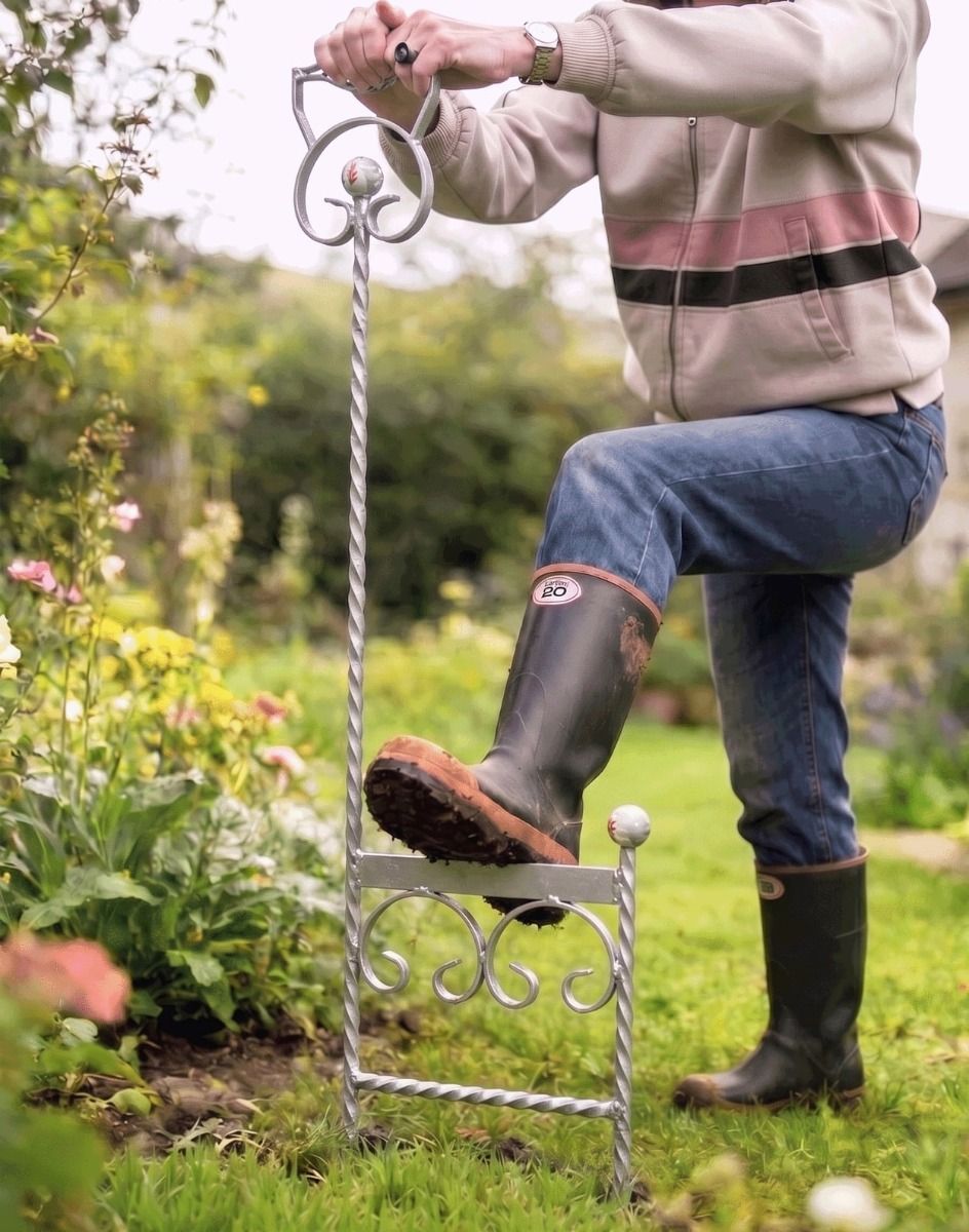 A Silver Boot Scraper Being Used Outside by a Gardener Next to a Flower Border - Digital Illustration