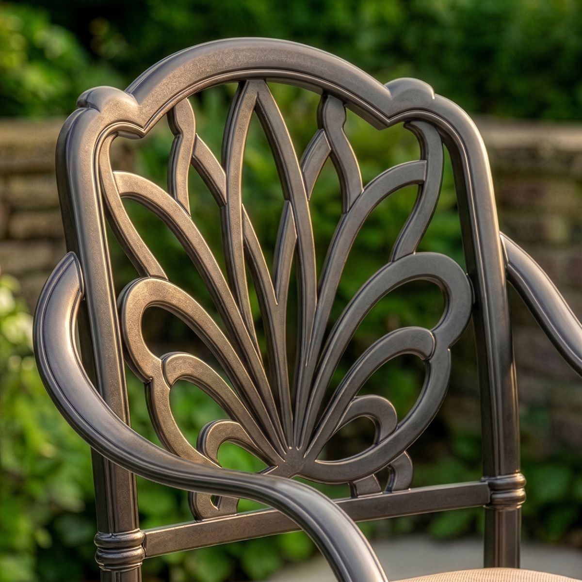 Aged Black "Moreville" Eight Seater Furniture Set in Situ Outside on a Patio close up of chair backing Digital illustration