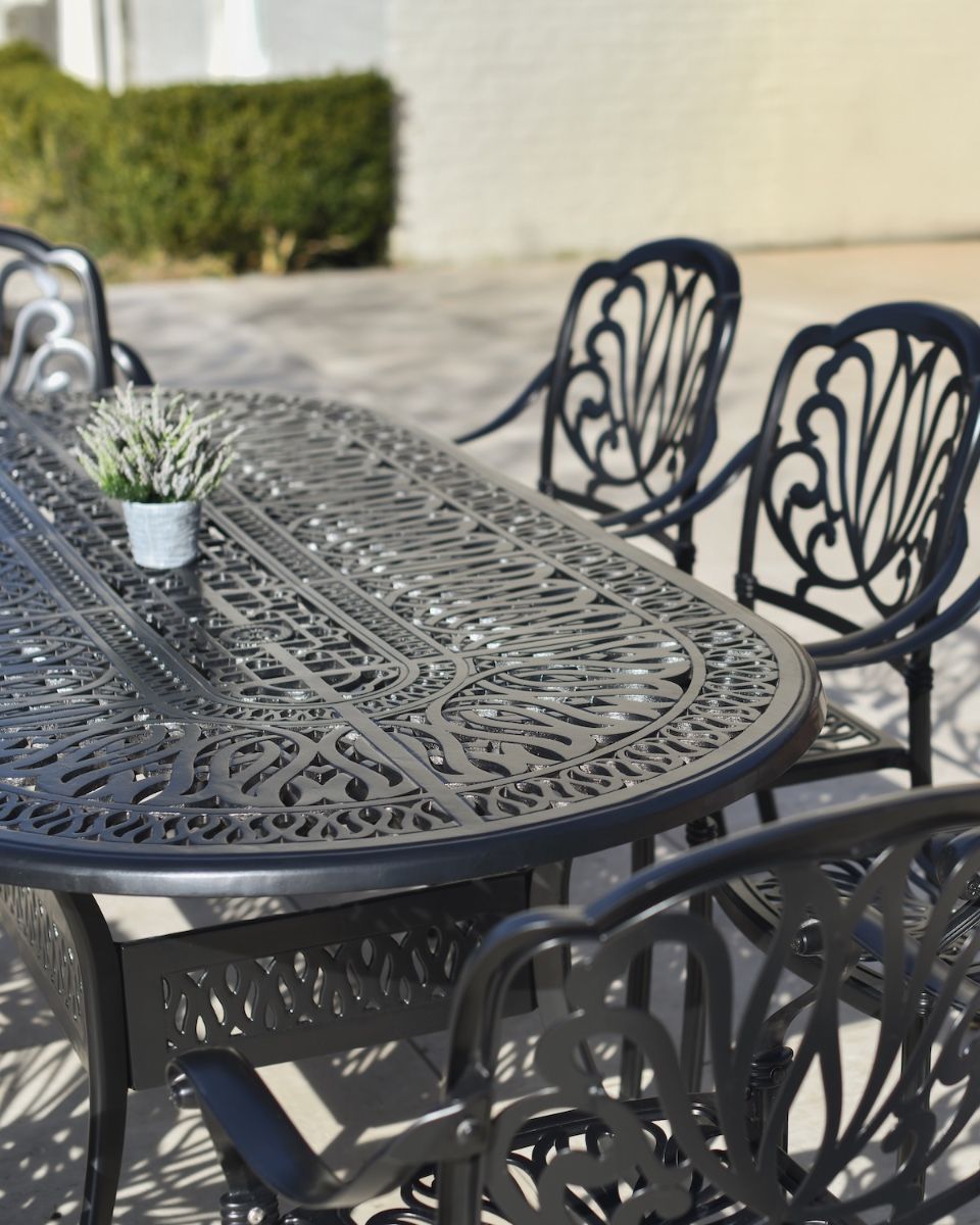 Aged Black "Moreville" Eight Seater Furniture Set in Situ Outside on a Patio close up of rounded table edge
