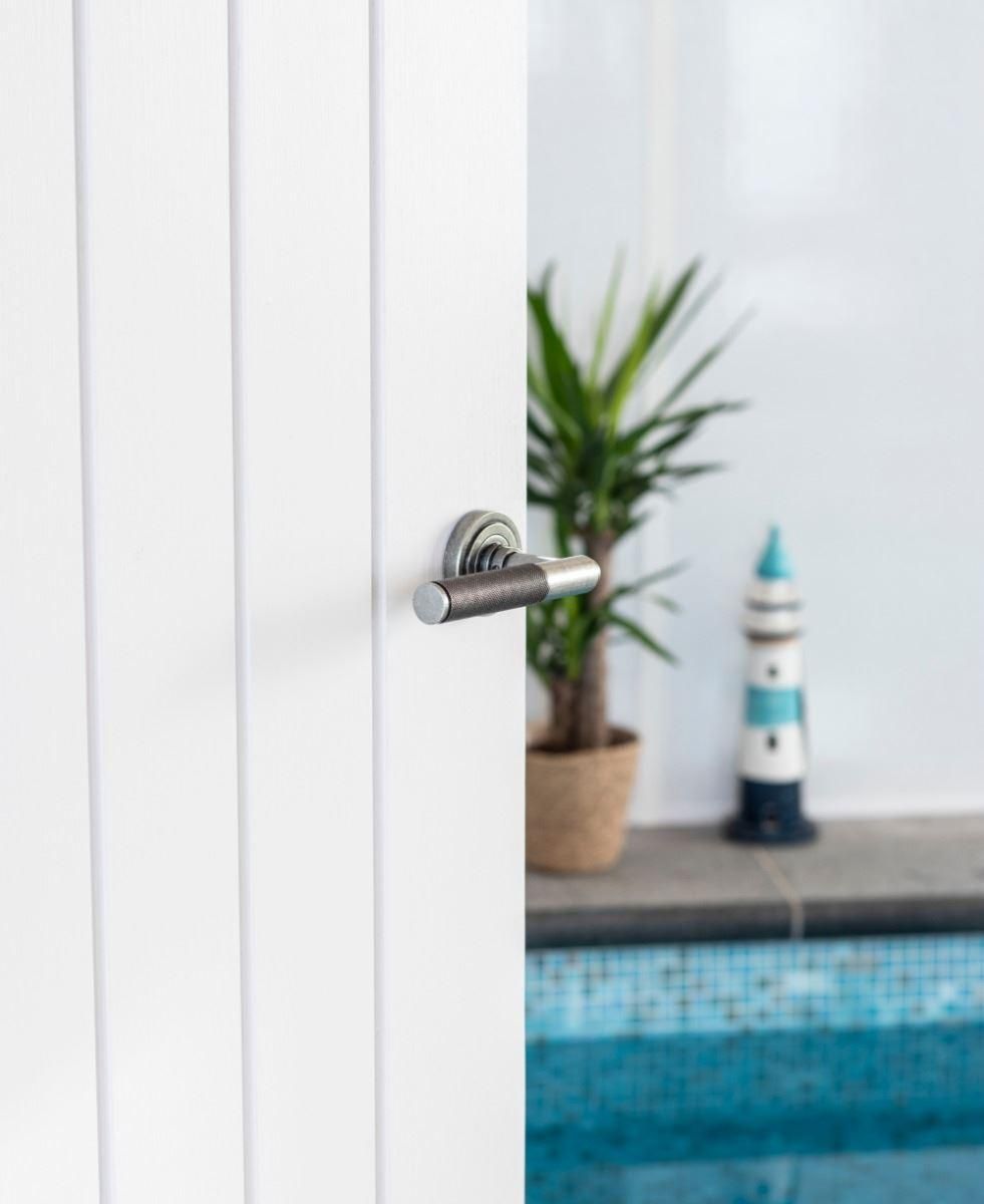 Aged Pewter Textured Unsprung Lever Door Handle on Art Deco Rose in Situ