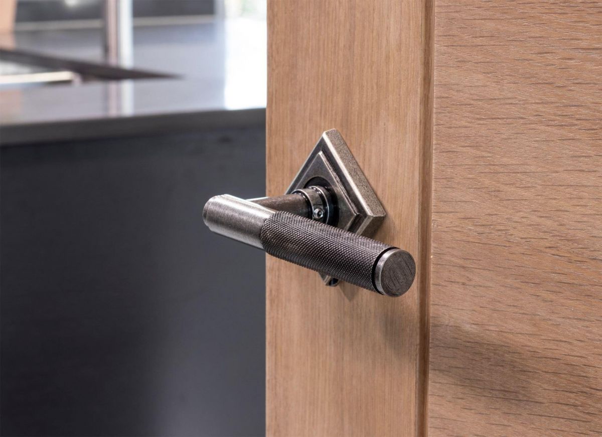 Aged Pewter Textured Unsprung Lever Door Handle on Diamond Rose in Situ