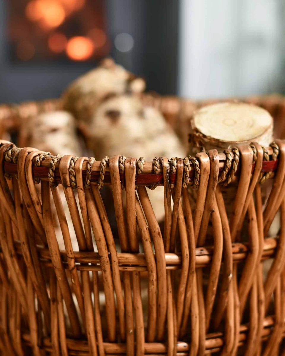 Close-Up of Aged Wicker Log Basket with Metal Handles in Situ