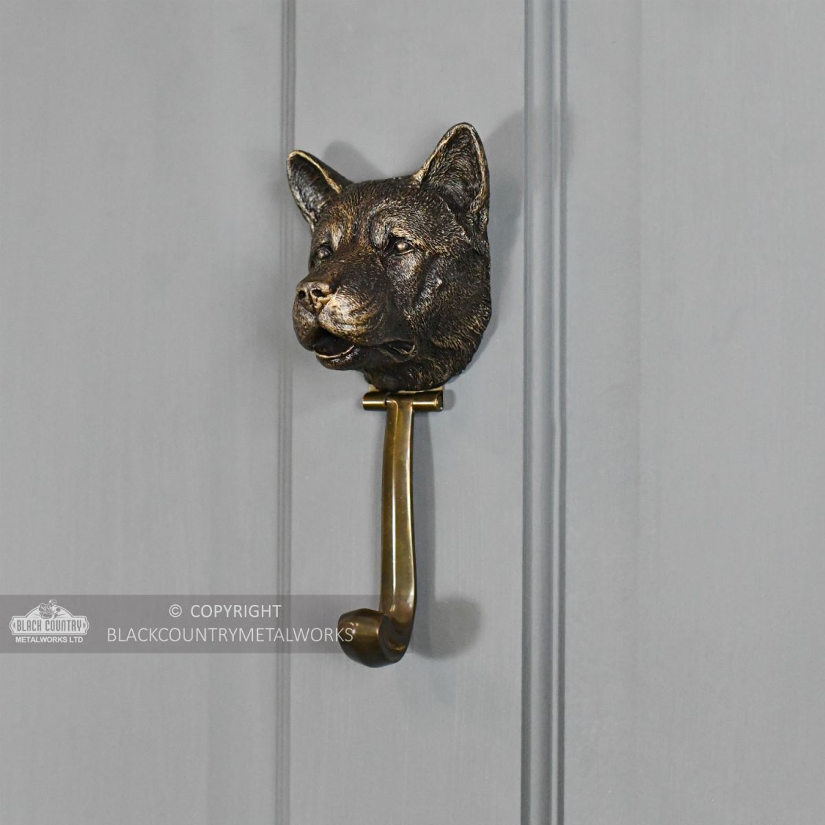 Bronze Finish Akita Door Knocker in Situ on a Grey Door