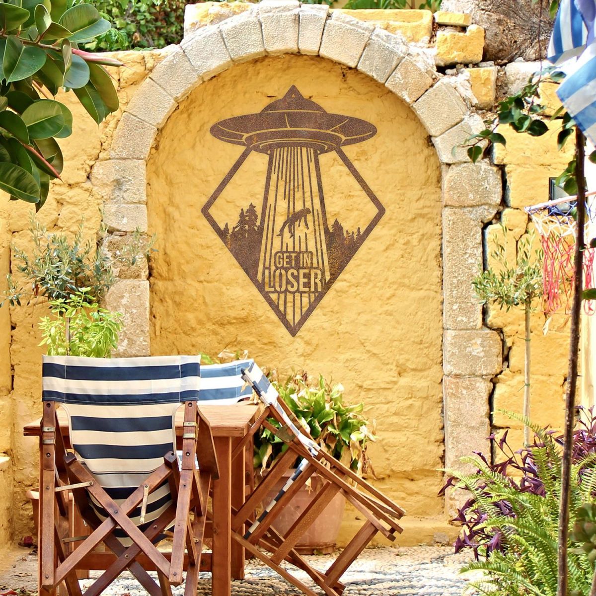 "Get in Loser" Alien Wall Art on a Yellow Brick Wall