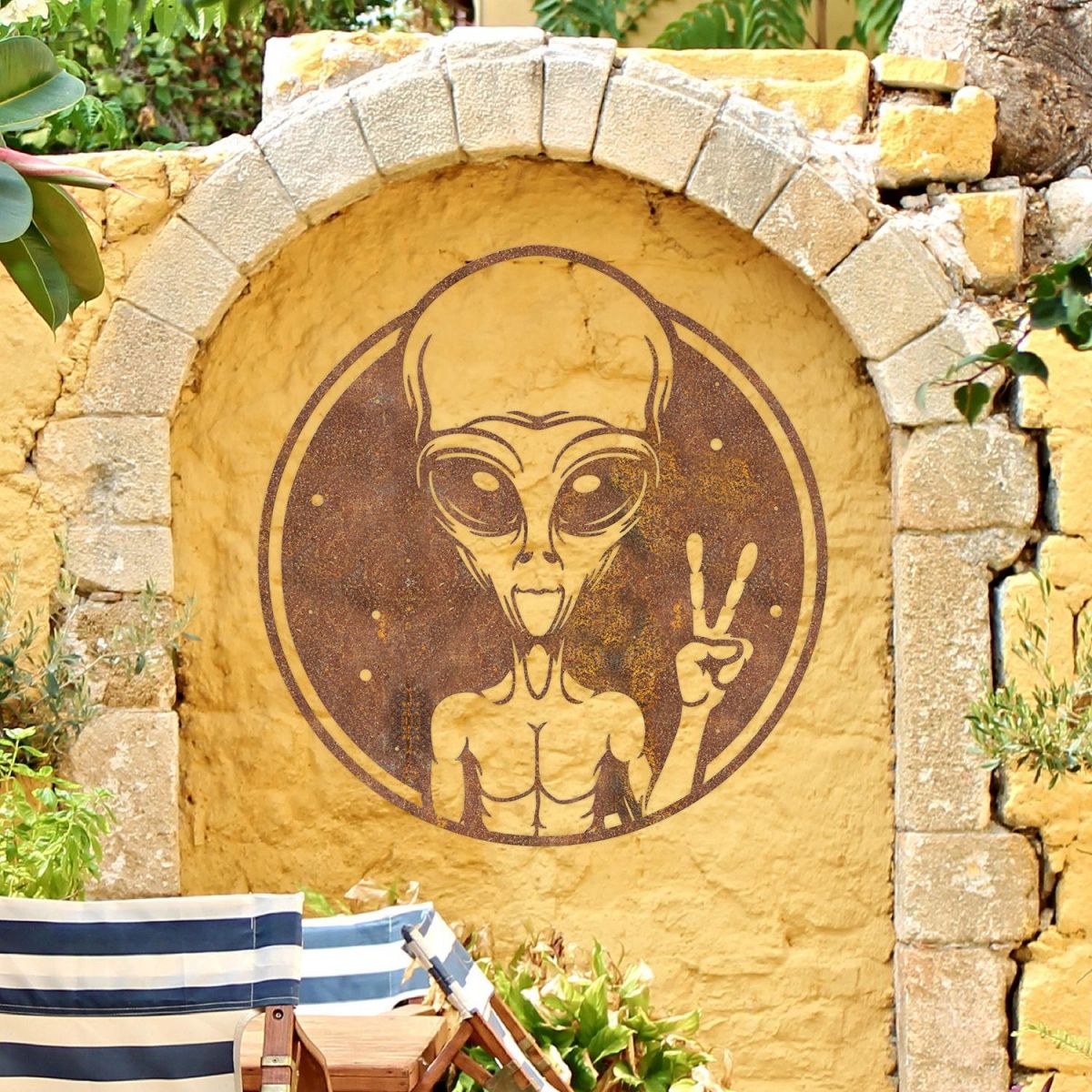 Peace Sign Alien Wall Art in Situ on a Yellow Garden Wall Peace Sign Alien Wall Art in Situ on a Yellow Garden Wall