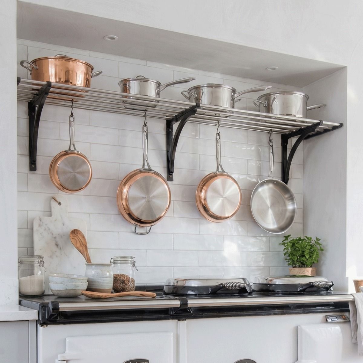 An Aga Inspired Stainless Steel Pot Rack Available in Various Sizes in a Tiled Kitchen Alcove Supporting Kitchen Utensils - Digital Illustration