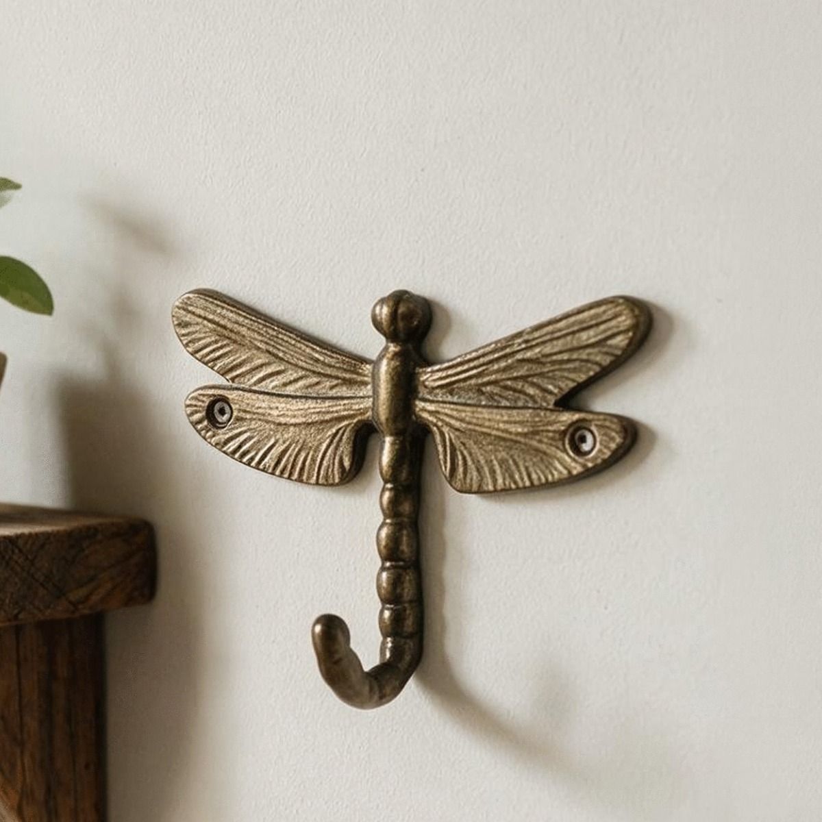 An Antique Brass Dragonfly Wall Hook On a Modern Interior Home Wall - Digital Illustration 