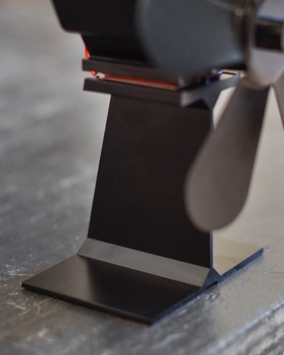 Close up of base on five blade heat powered wood stove fan Close up of base on five blade heat powered wood stove fan