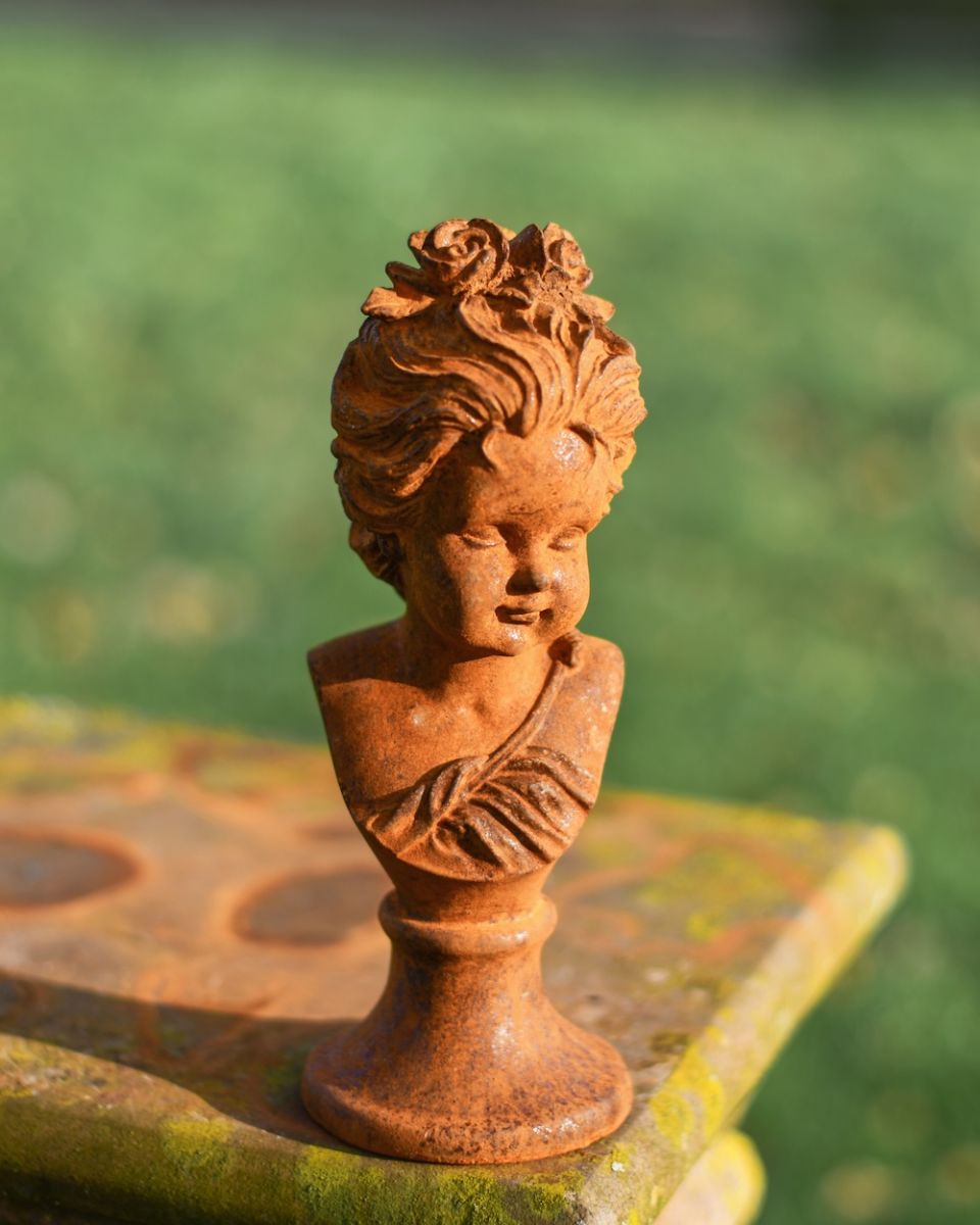 Angled view of rustic finish cast iron garden bust