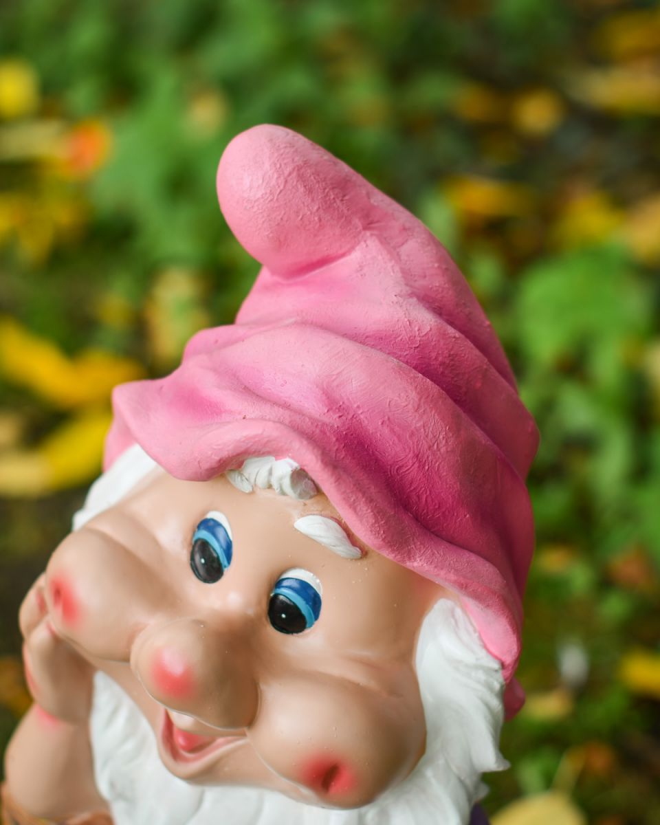 Angled close up of colourful garden gnome ornament Angled close up of colourful garden gnome ornament