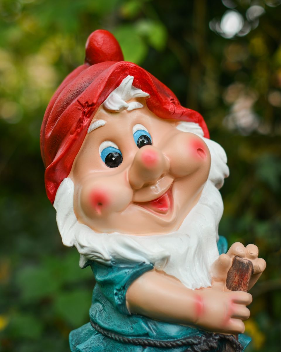 Close up of intricate face detail on colourful garden gnome ornament