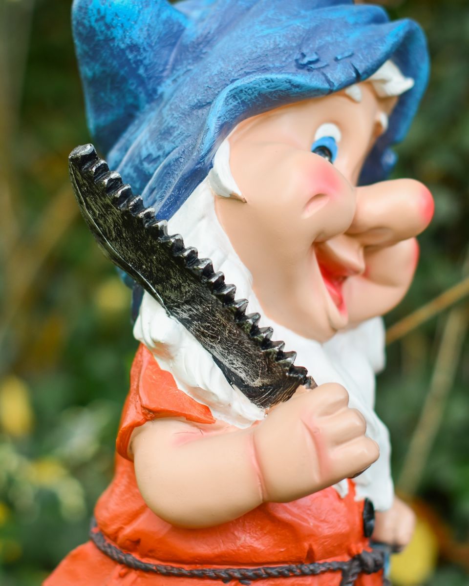 Close up of saw detail on colourful outdoor gnome sculpture