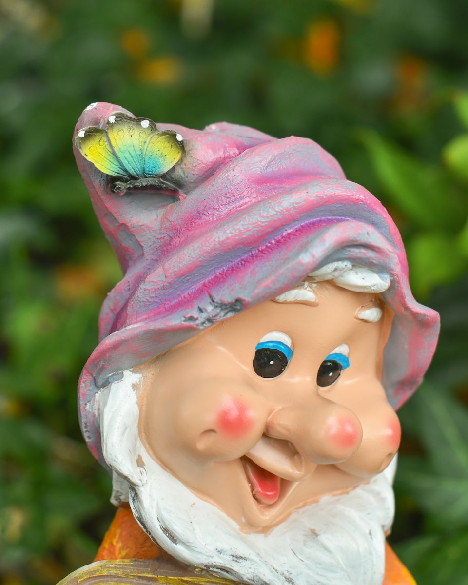 Angled close up of butterfly detail on colourful garden gnome statue