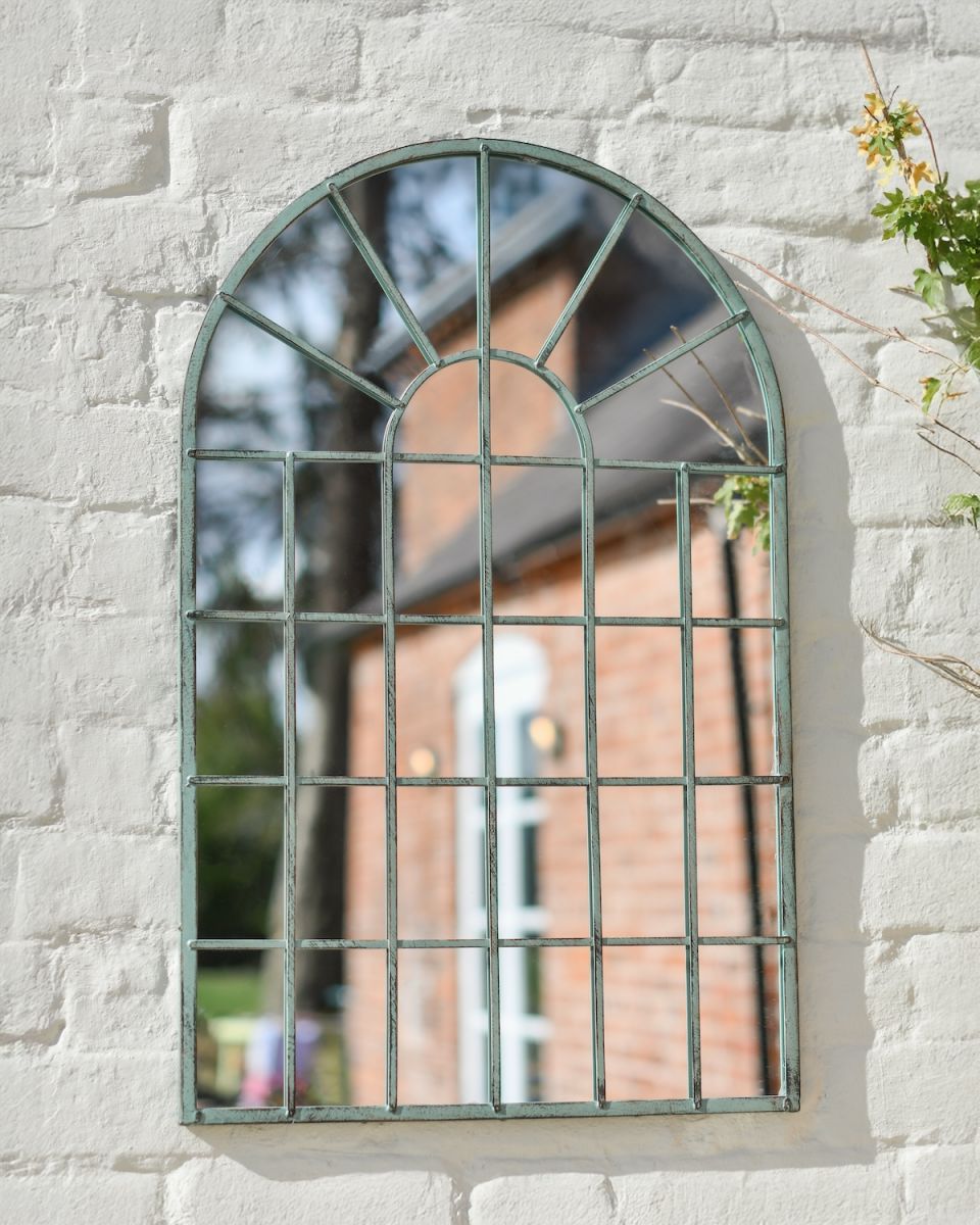 Angled close up of rustic green finish garden mirror