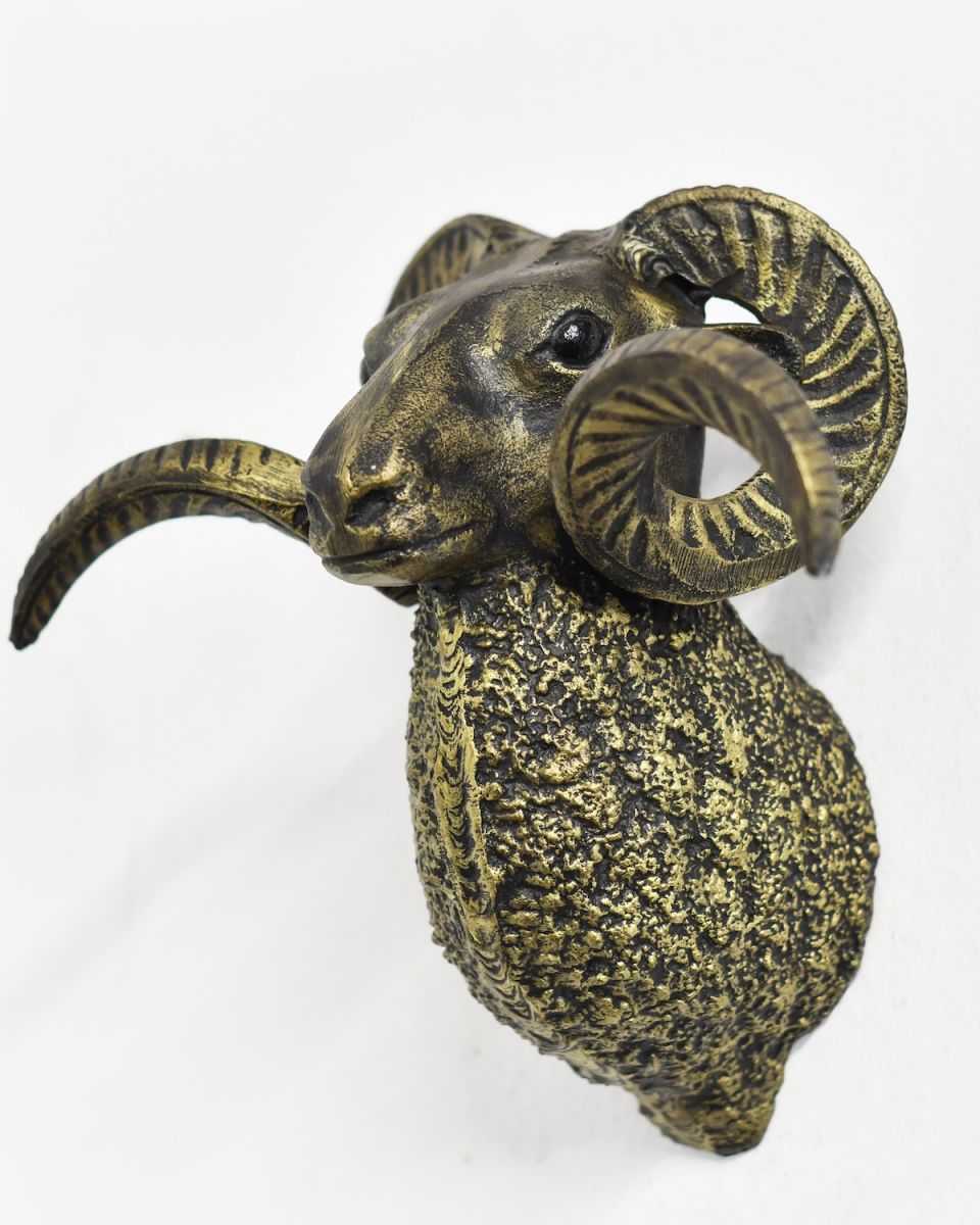 Angled view of black and gold animal wall bust
