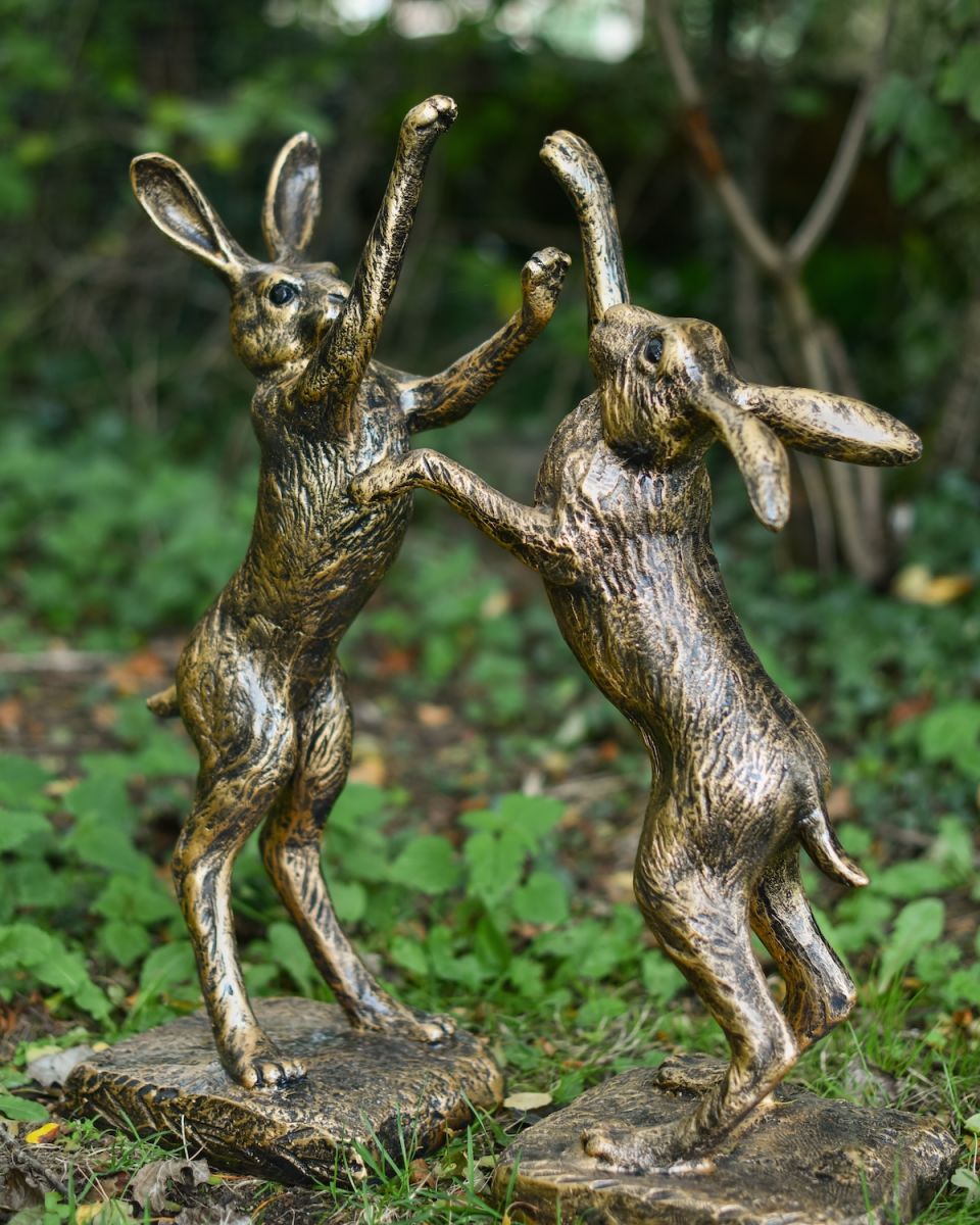 Angled view of fighting hares garden statues