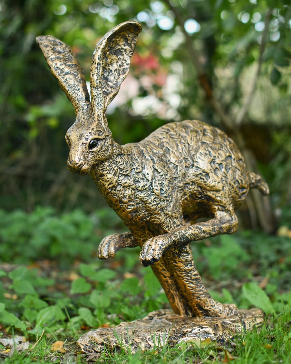Angled view of gold hare garden statue