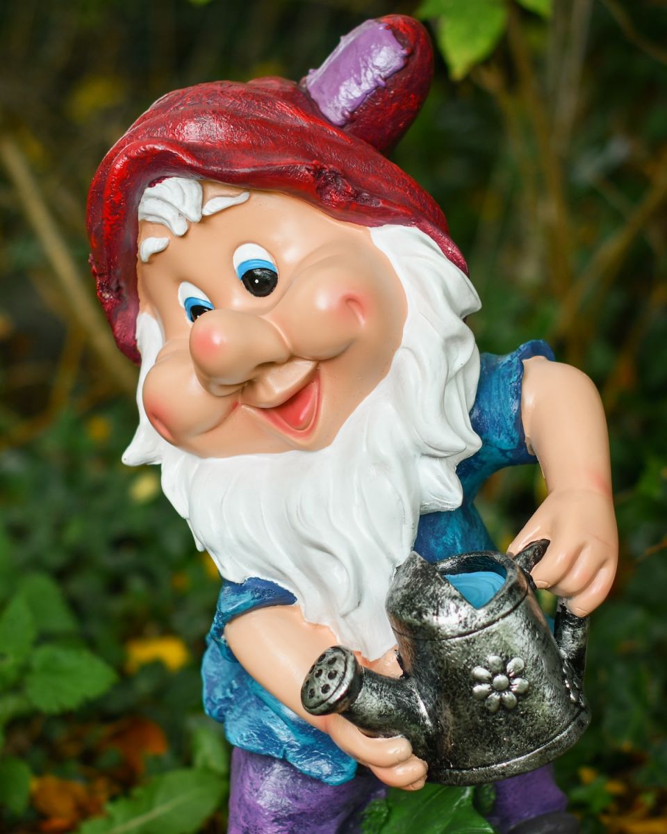 Angled close up of colourful garden gnome sculpture