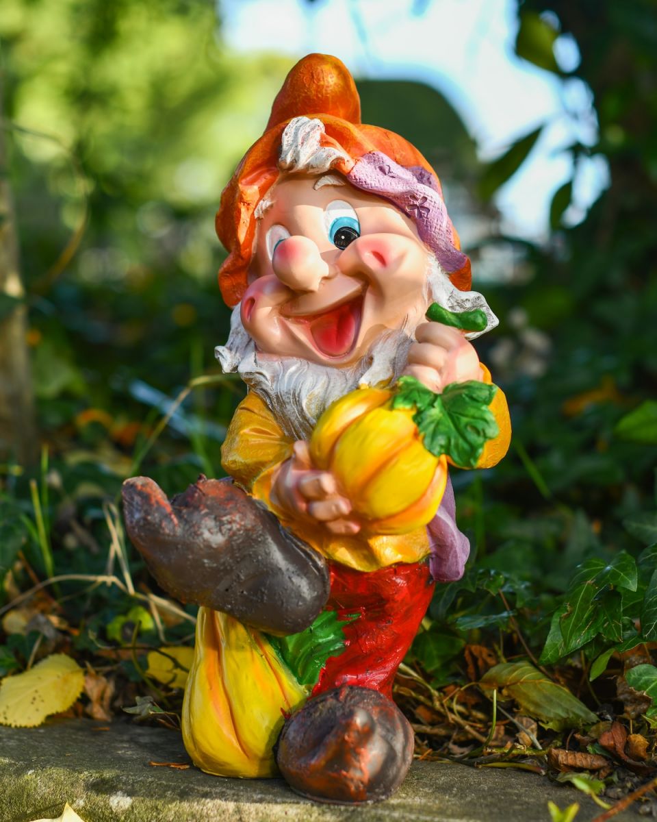 Angled view of colourful garden gnome statue