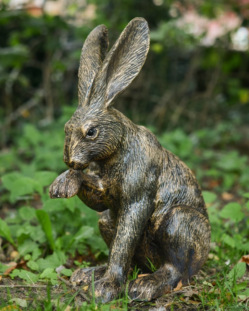 Angled view of gold hare patio sculpture
