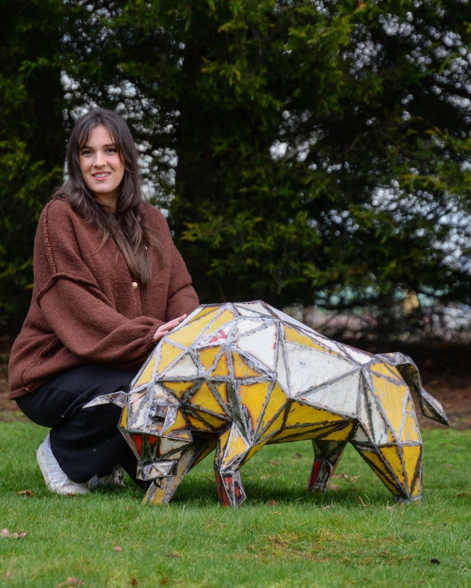 ‘Toro’ the Bull Upcycled Oil Drum Garden Sculpture with lady crouched down next to bull sculpture