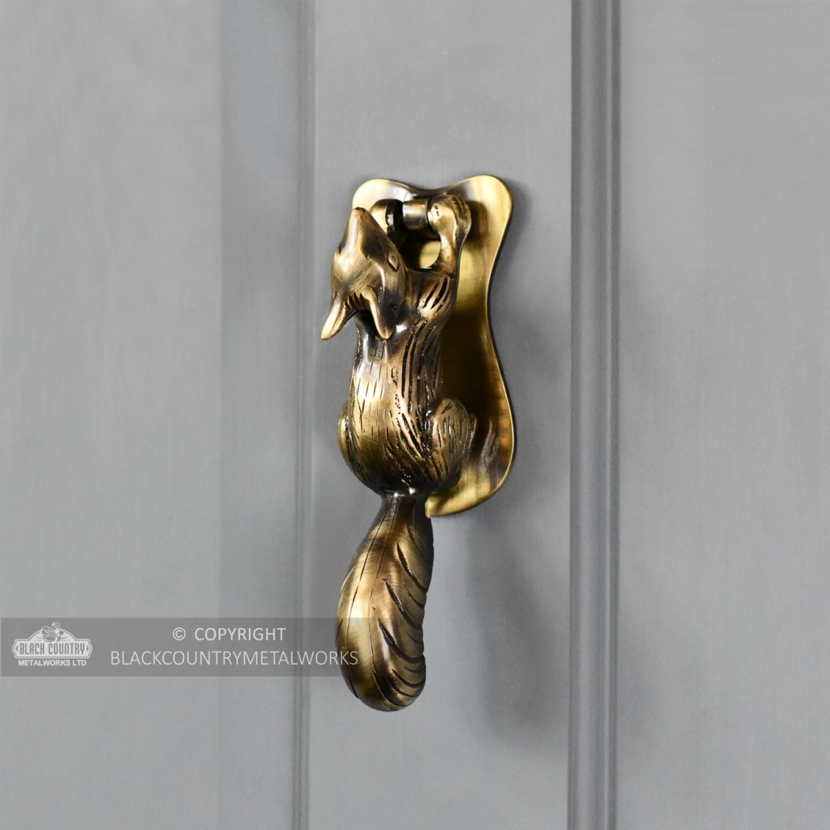 Antique Brass Squirrel door knocker on grey door Antique Brass Squirrel door knocker on grey door