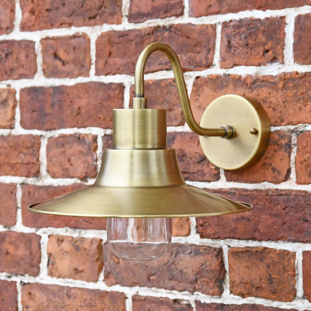 Antique Brass Traditional Barn Wall Light on Situ on a Brick Wall Antique Brass Traditional Barn Wall Light on Situ on a Brick Wall