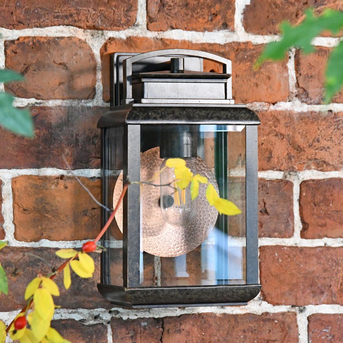 Antique Bronze Hanging Wall Light With Reflector Plate in Use Outdoors