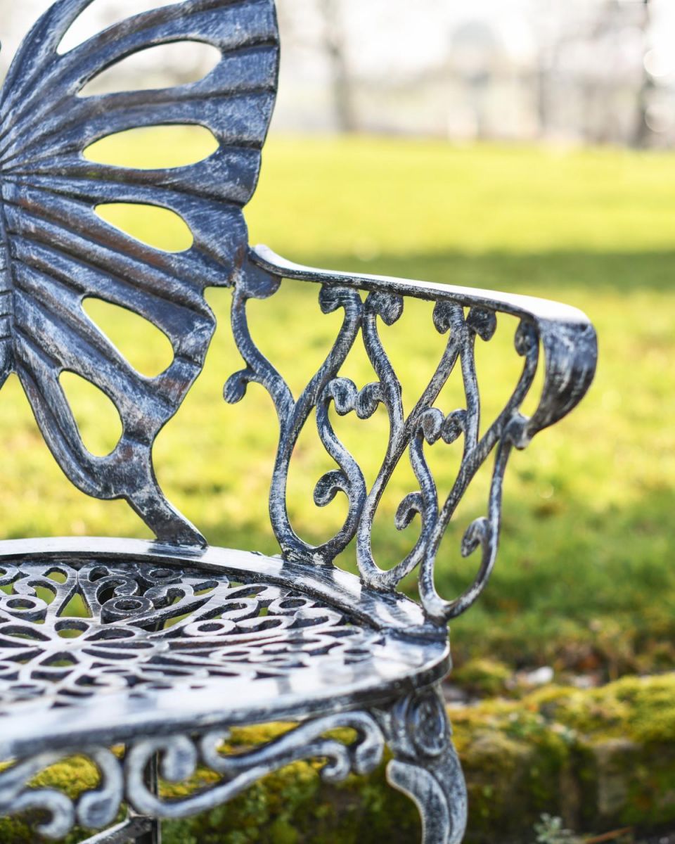 Close Up Of Antique Silver Butterfly Design Two Seater Bench Arm Rests Close Up Of Antique Silver Butterfly Design Two Seater Bench Arm Rests