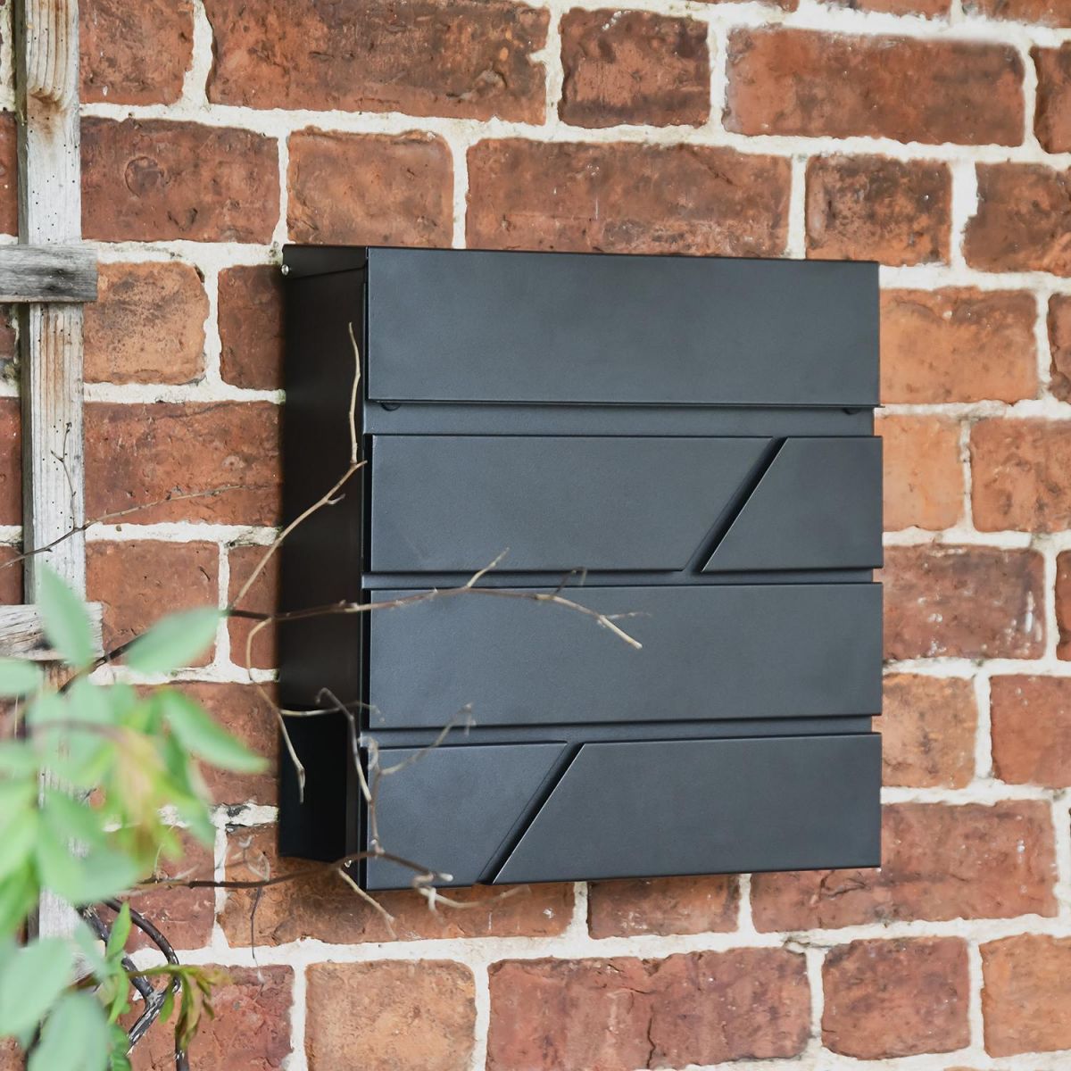 "Arlington" Black Modern Wall Mounted Post Box in Situ on a Brick Wall