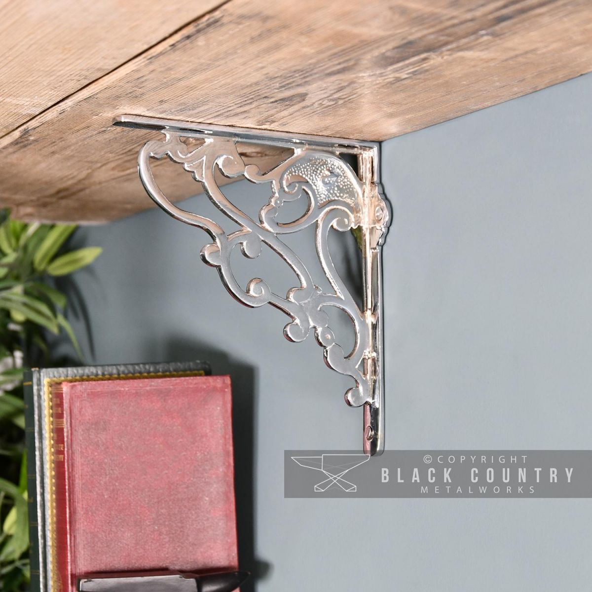 "Art Nouveau" Polished Aluminium Shelf Bracket Holding up a Wooden Shelf
