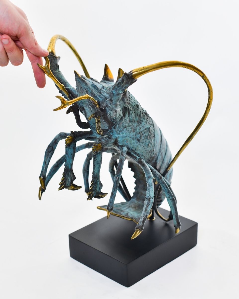 Aurelian Sentry Lobster Sculpture in Cast Brass with hand in shot for scale