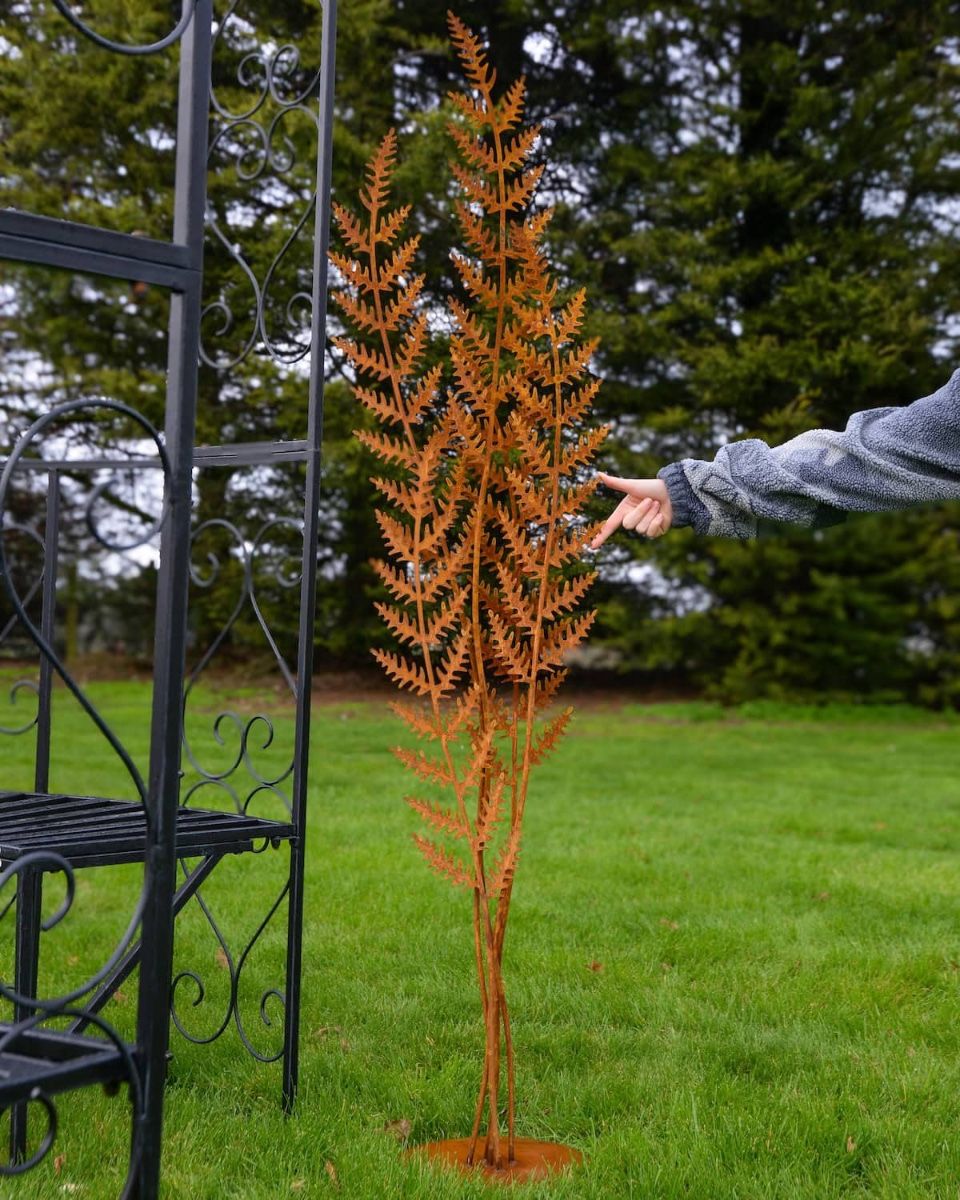 Autumnal Fern Garden Sculpture with Hand in Shot for Scale
