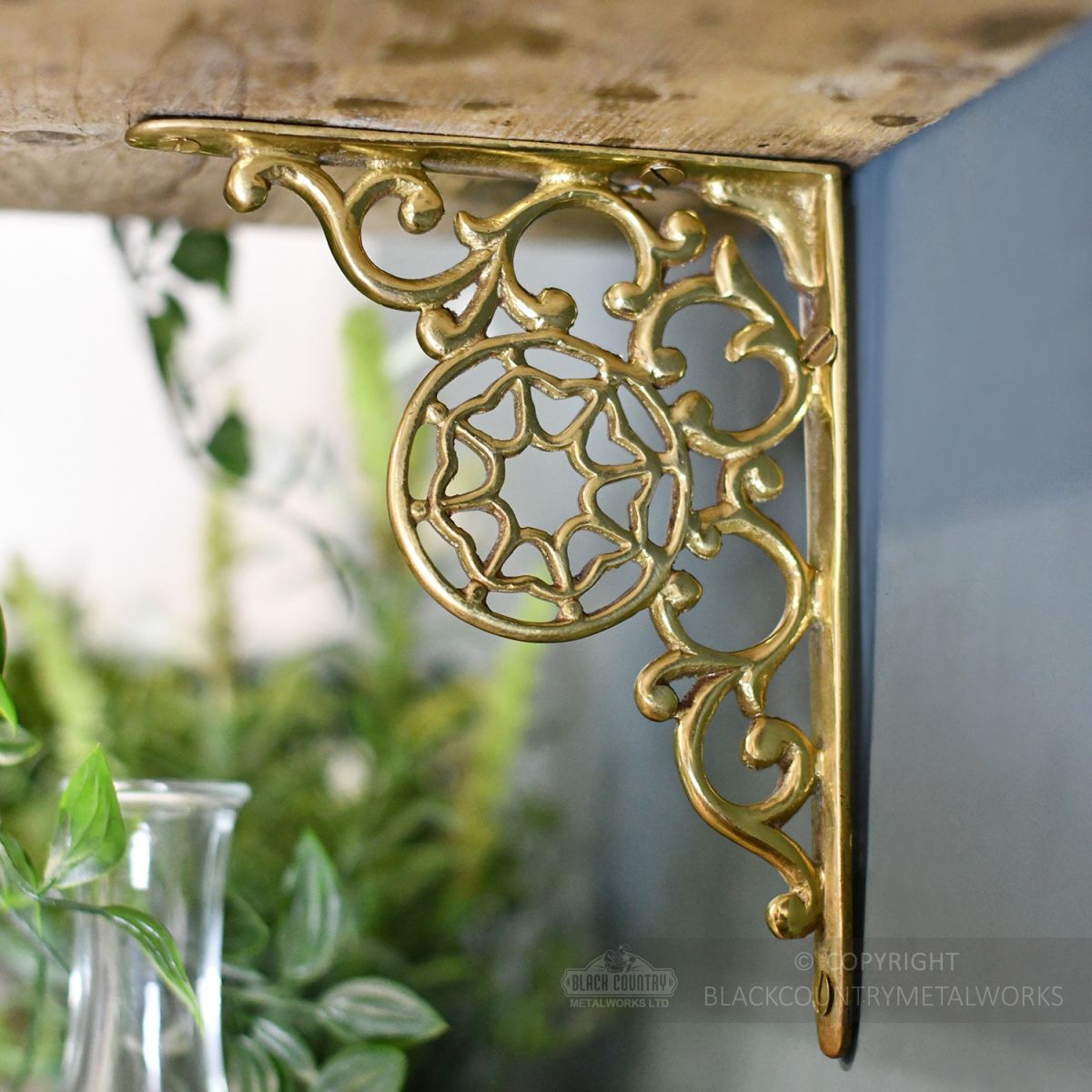 Side view of highly polished brass bracket