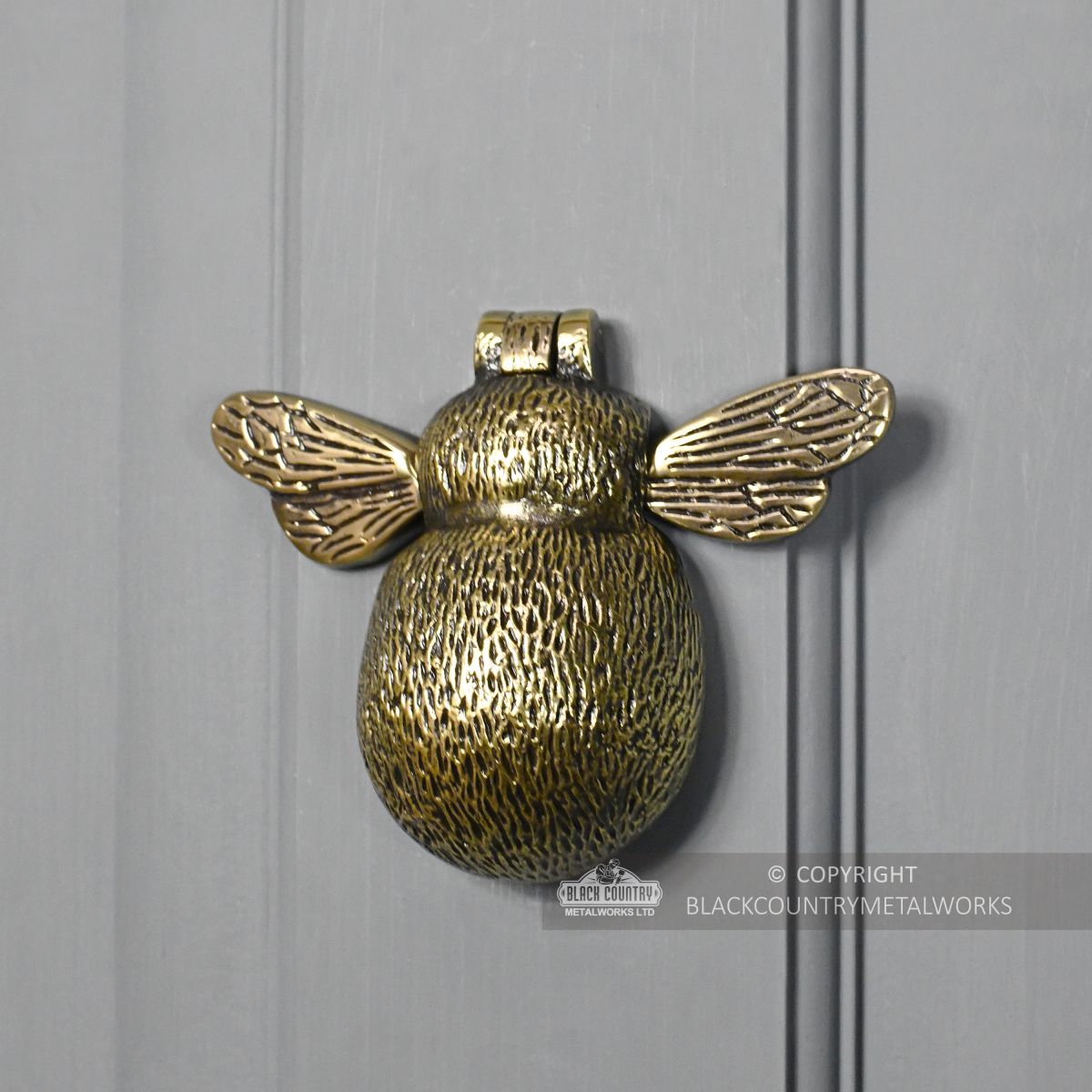 Bumblebee door knocker on grey door
