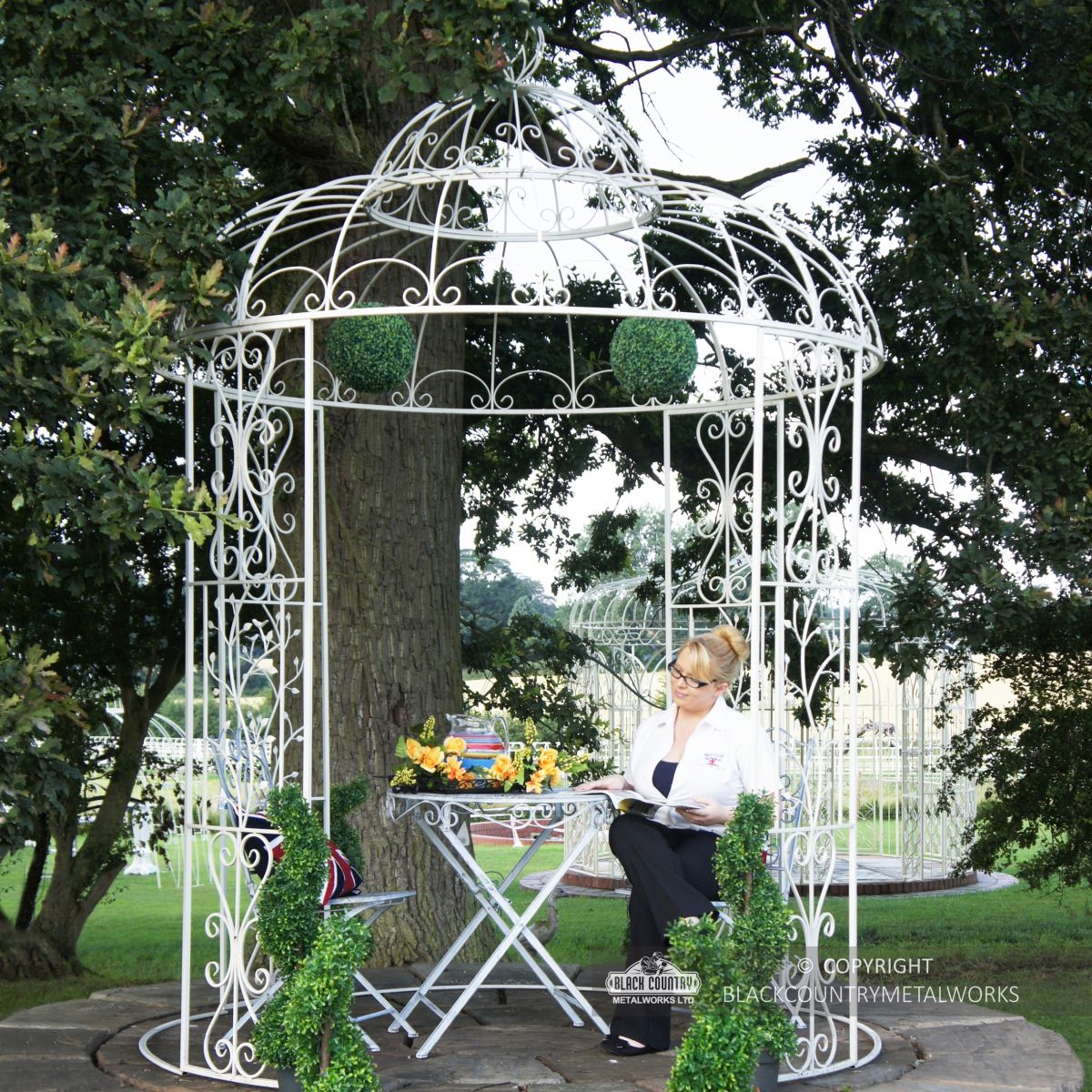 Iron ornate scroll gazebo in garden