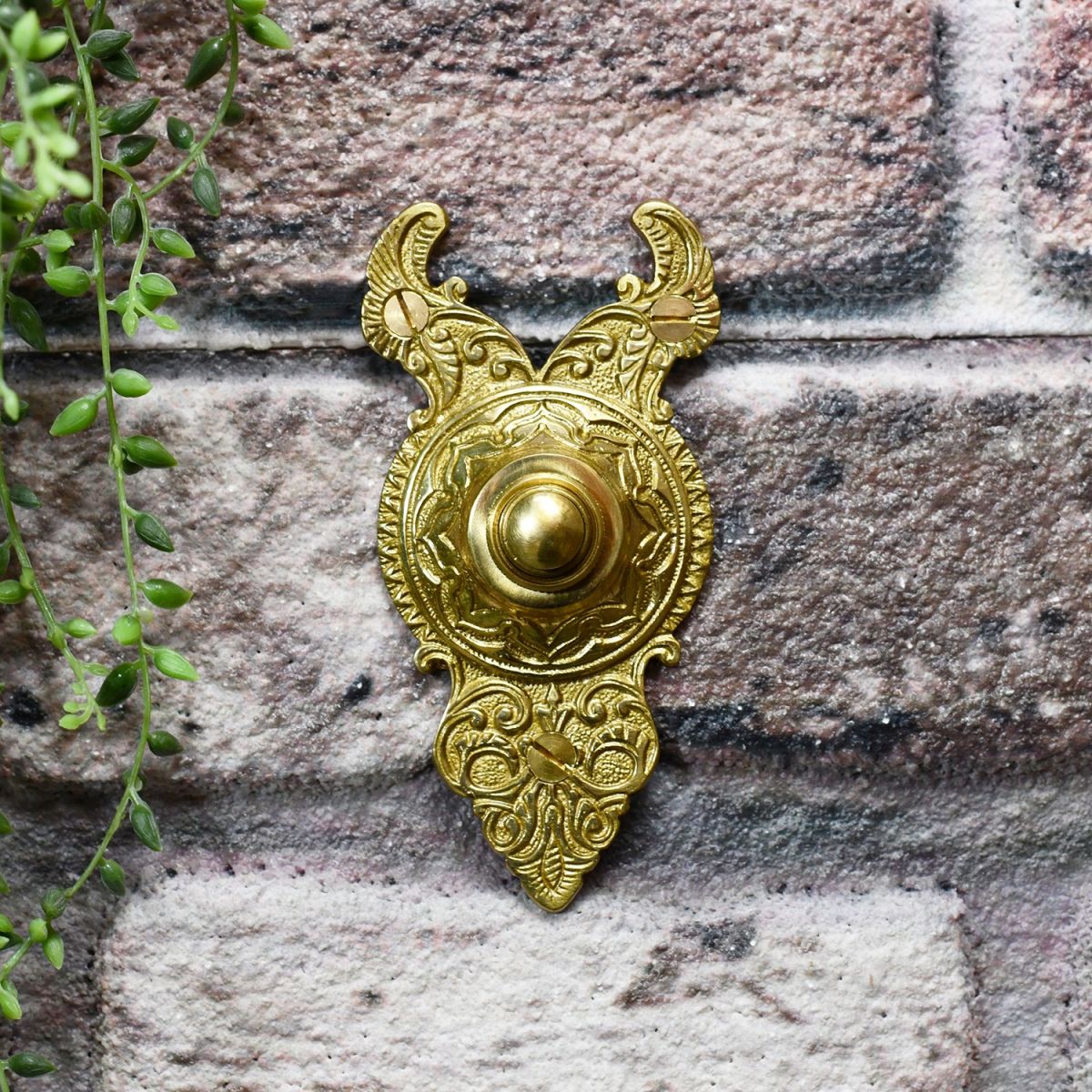 Polished Brass Bell Push ornate design on brick wall