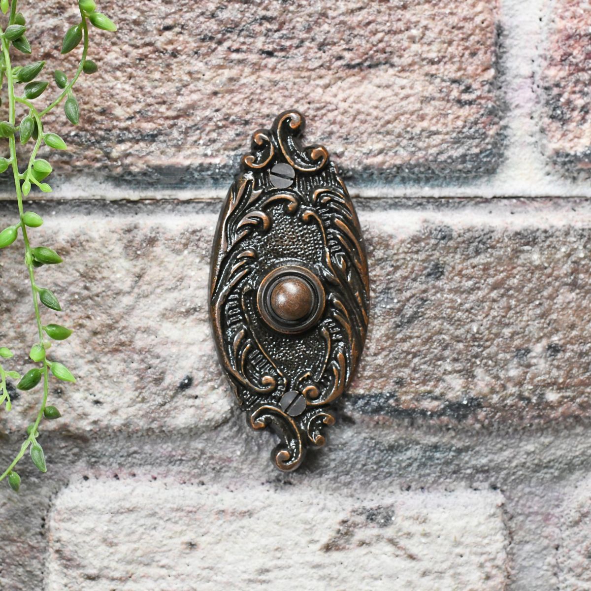 Burnished Copper Door Buzzer on Brick wall
