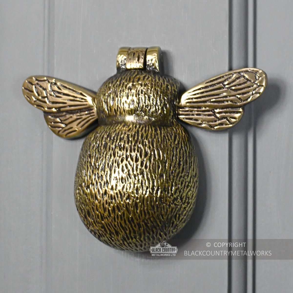 Honey Bee door knocker on grey door