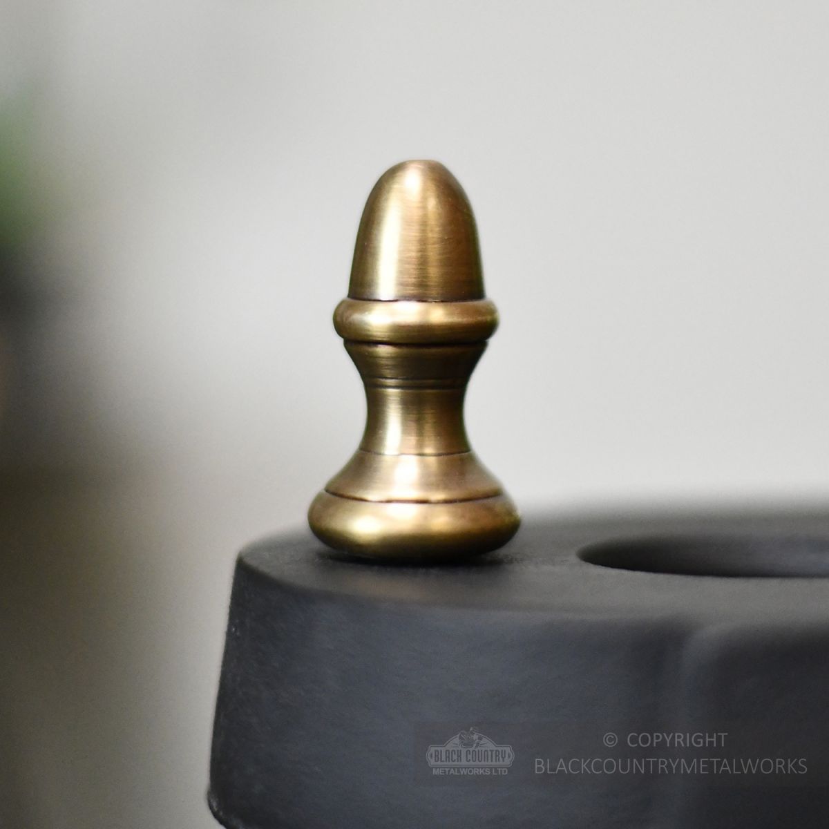 Solid brass finials on umbrella stand
