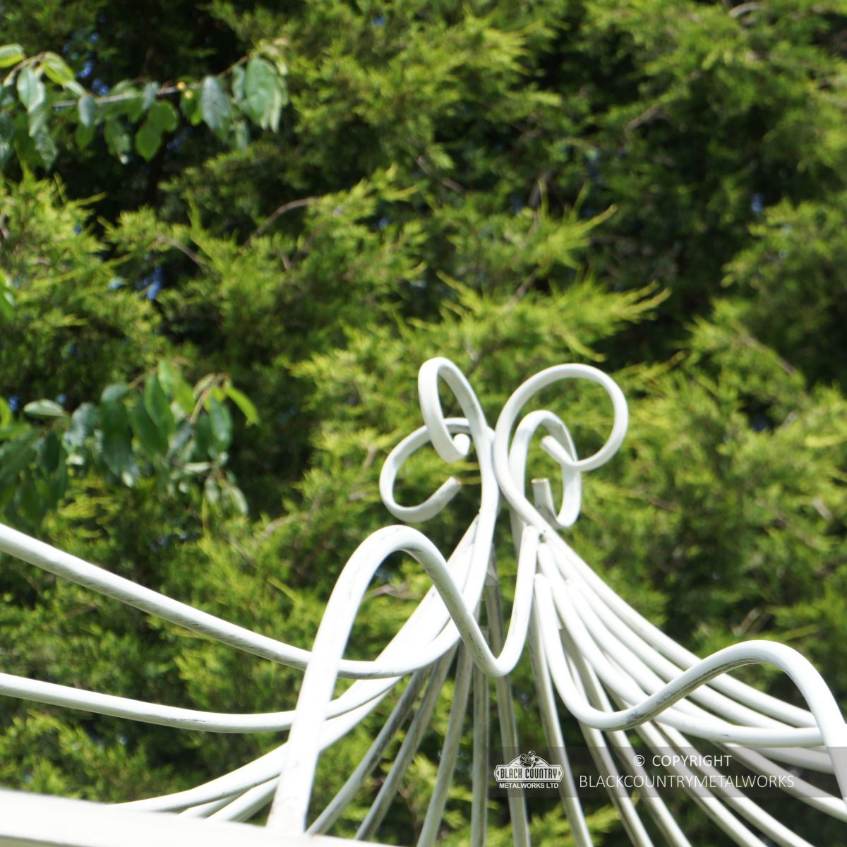 Ornate scrolled finial on top of roof on gazebo